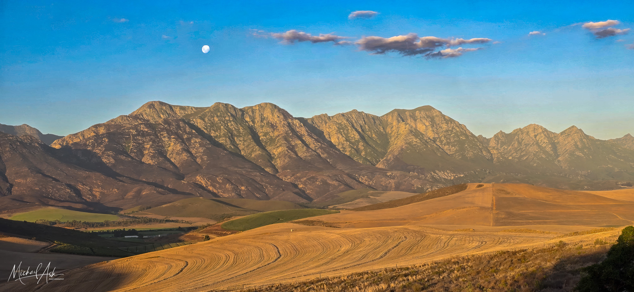Landscape & Views Golden wheat fields with Riviersonderend Mountain Range backdrop and moon rising in the sky at dusk