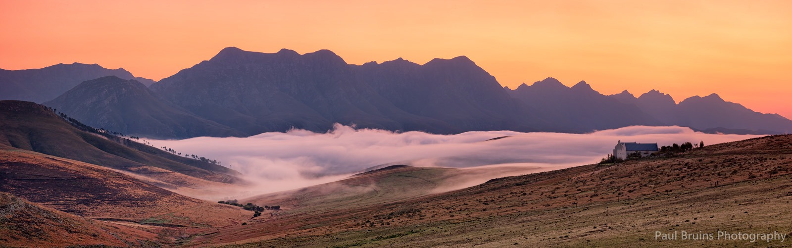 Landscape & Views Spectacular sunrise landscape showing dramatic mountain ranges, rolling mist, orange alpenglow, and property on hillside